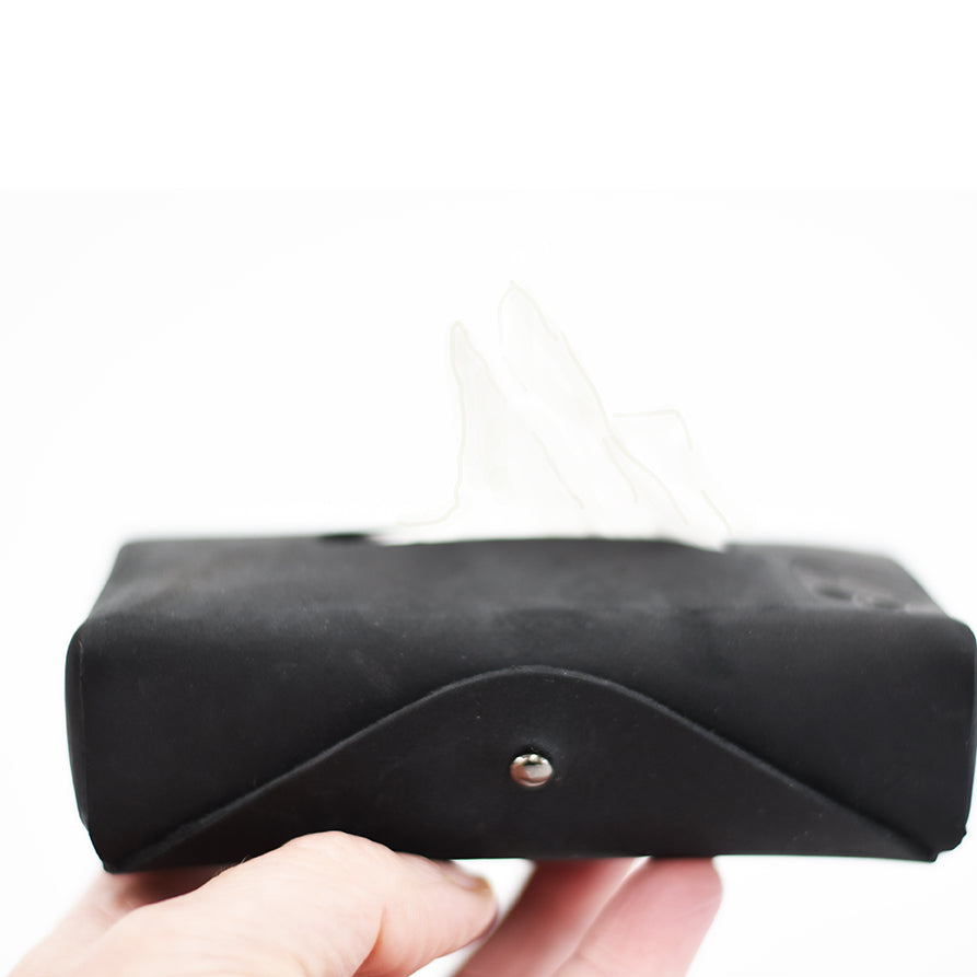 Black leather wallet held by a hand on a white background
