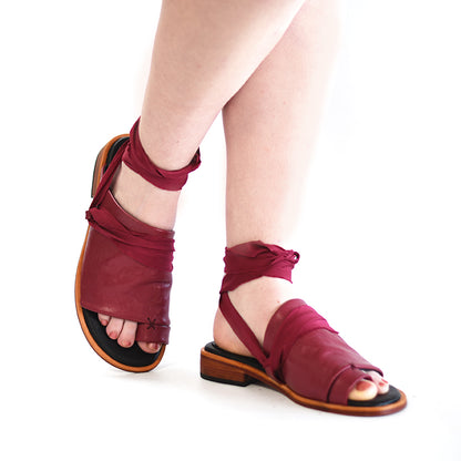 Sweeping line across top and sides of foot on Raspberry Red Vulcan Slides